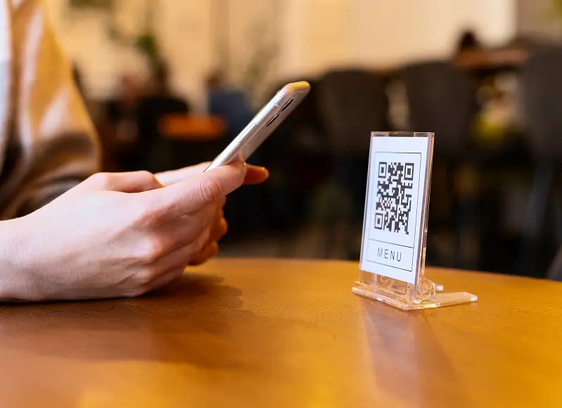 Person scanning QR code for storage reservation